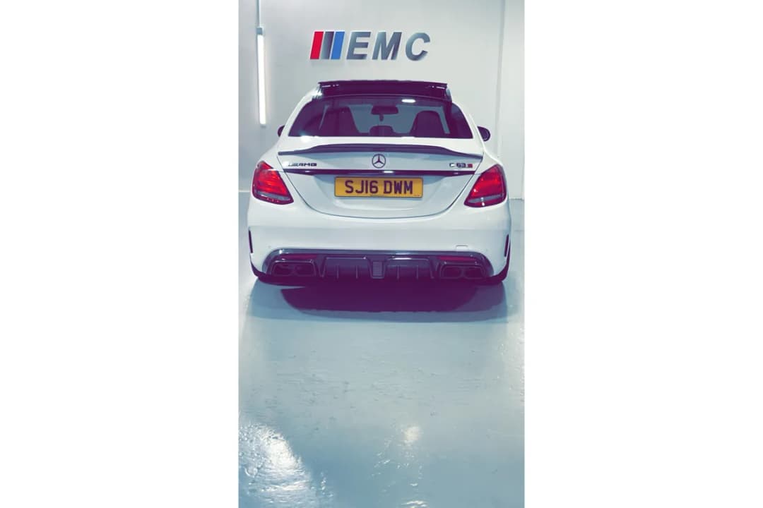 White Mercedes-AMG C63 saloon ready for handover on the East Midland Cars forecourt